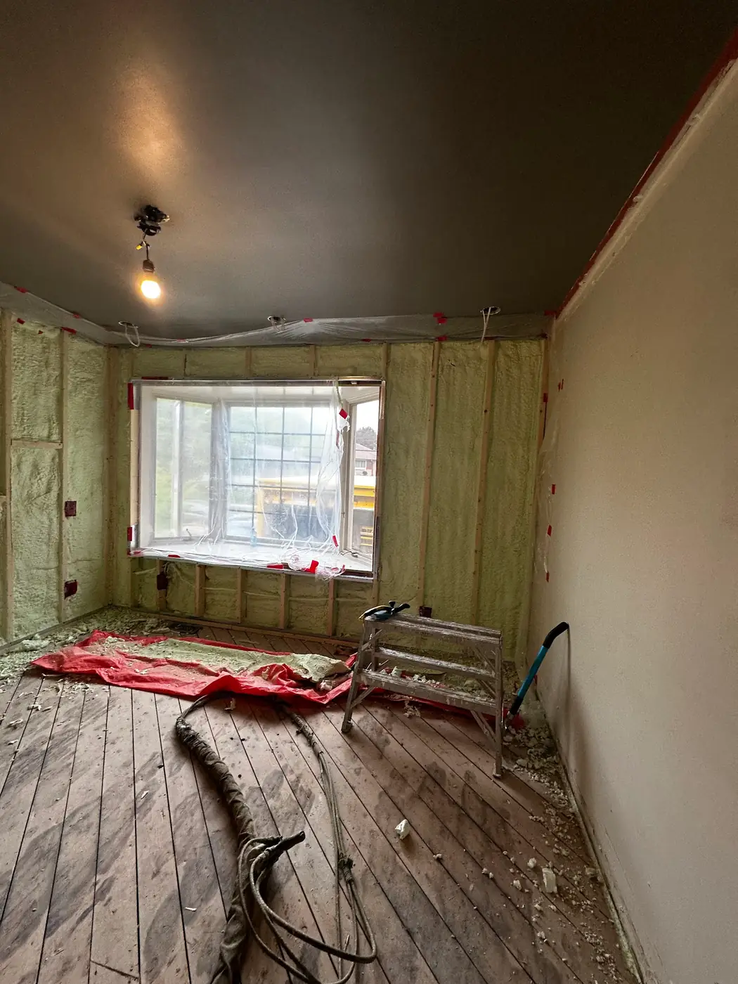 3.5" (R22) of 2lb closed-cell spray foam around poly-masked window framing in York, Toronto (Baby Point & High Park) [JOB-2025-05-29-01]